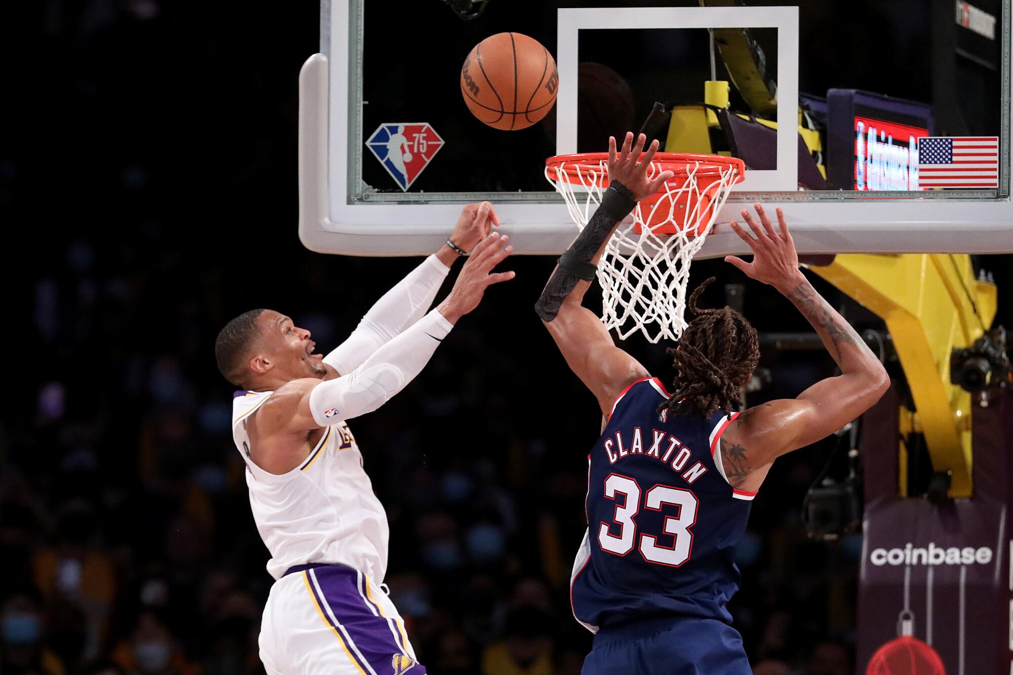 Lakers guard Russell Westbrook, left, has a slam-dunk attempt blocked by Brooklyn Nets forward Nic Claxton.
