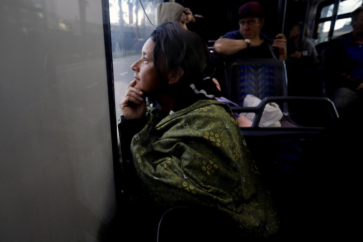 "I can't wait to take a shower and sleep and I know it will be a safe place," said Yasenia Valencia as she and others ride a bus from the homeless encampment along the Santa Ana River to a motel.