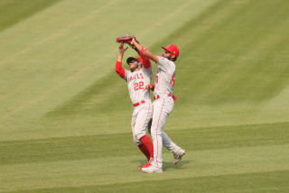 OAKLAND, CALIFORNIA - AUGUST 23: David Fletcher #22 and Jo Adell #59 of the Los Angeles Angels collide while catching a fly ball hit by Marcus Semien #10 of the Oakland Athletics in the sixth inning at RingCentral Coliseum on August 23, 2020 in Oakland, California. (Photo by Ezra Shaw/Getty Images)