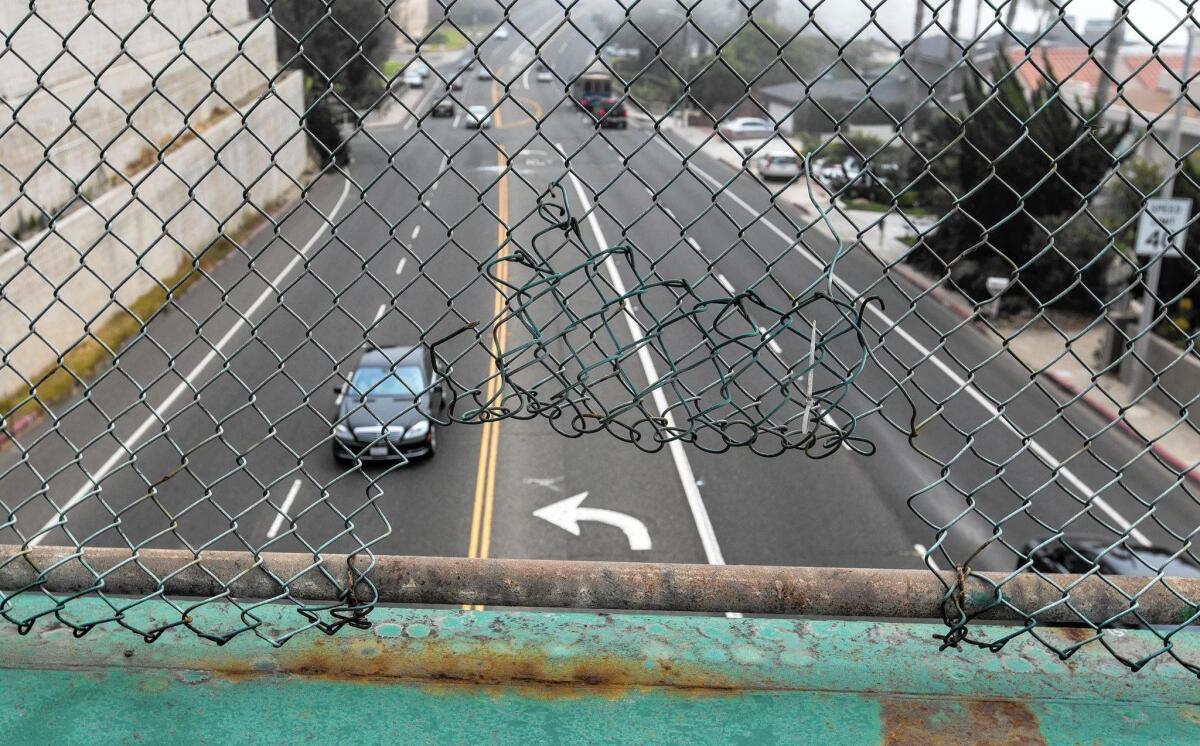 The safety fence on the pedestrian bridge is starting to show its age.