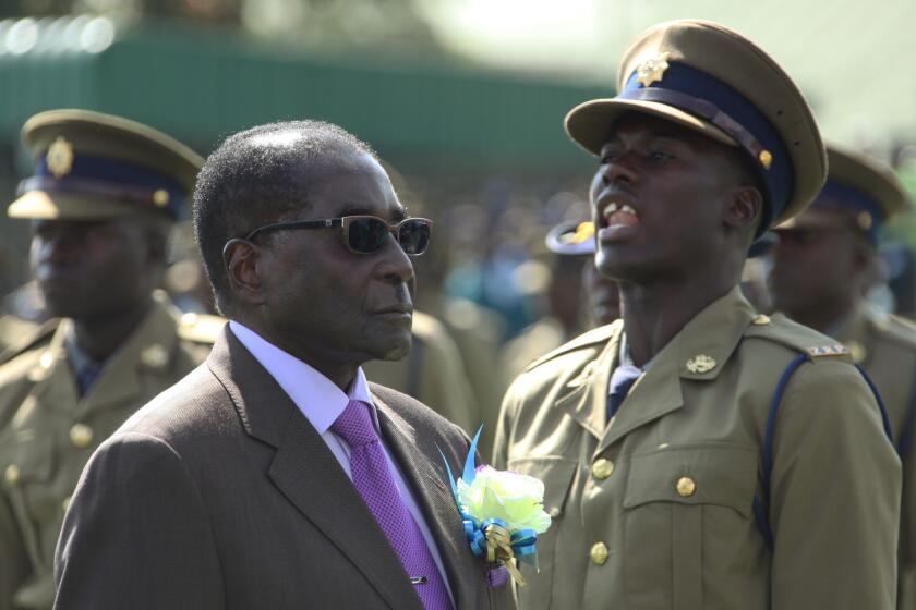 Zimbabwean President Robert Mugabe inspects an honor guard of police officers Thursday in Harare, the country's capital.