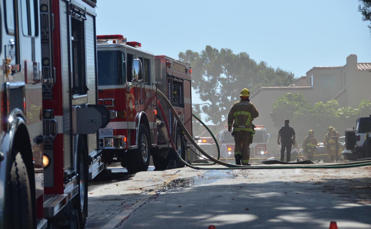 Firefighters and equipment at Promontory Point apartments in Newport Beach.