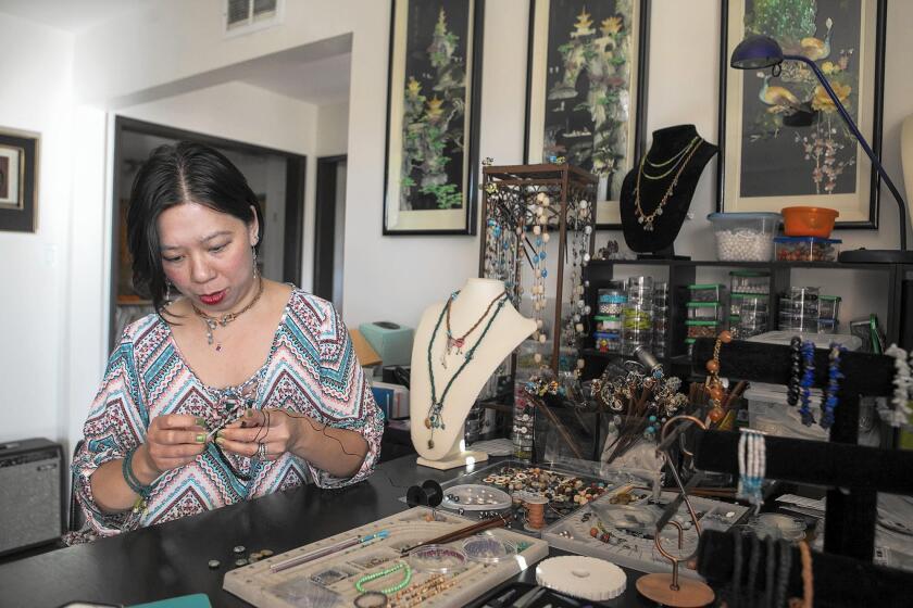 Kat Kwan works on handmade jewelry from her home in Fullerton.