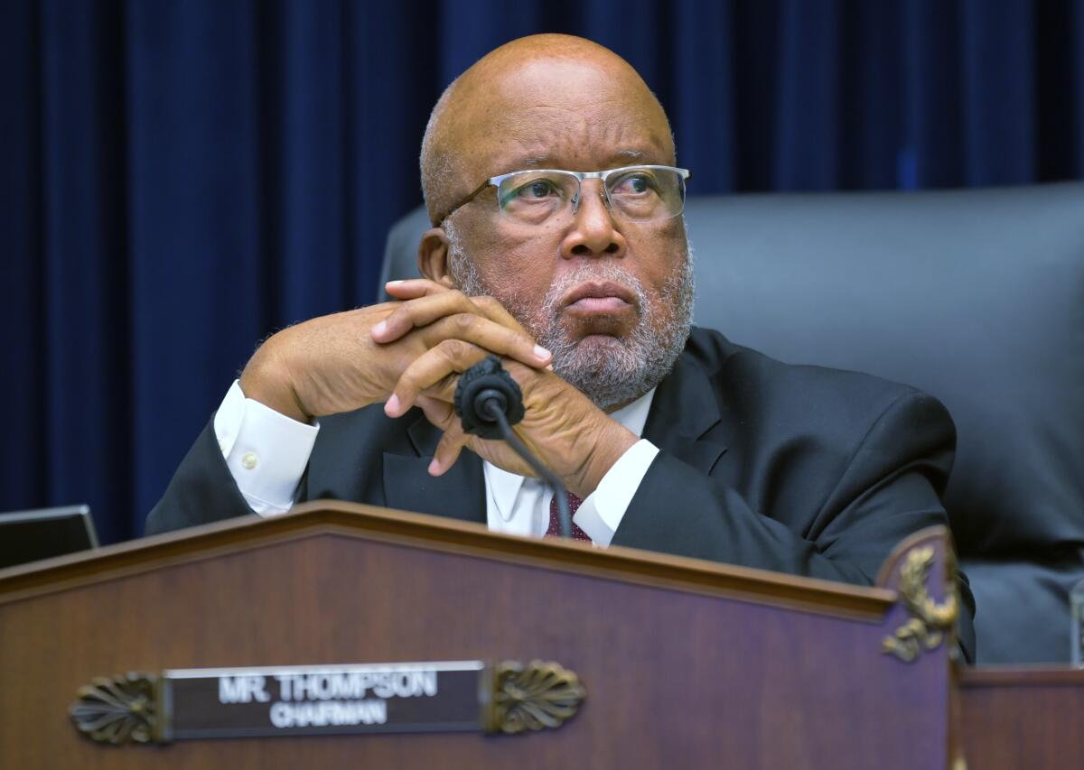 Rep. Bennie Thompson seated in a chair in front of a microphone