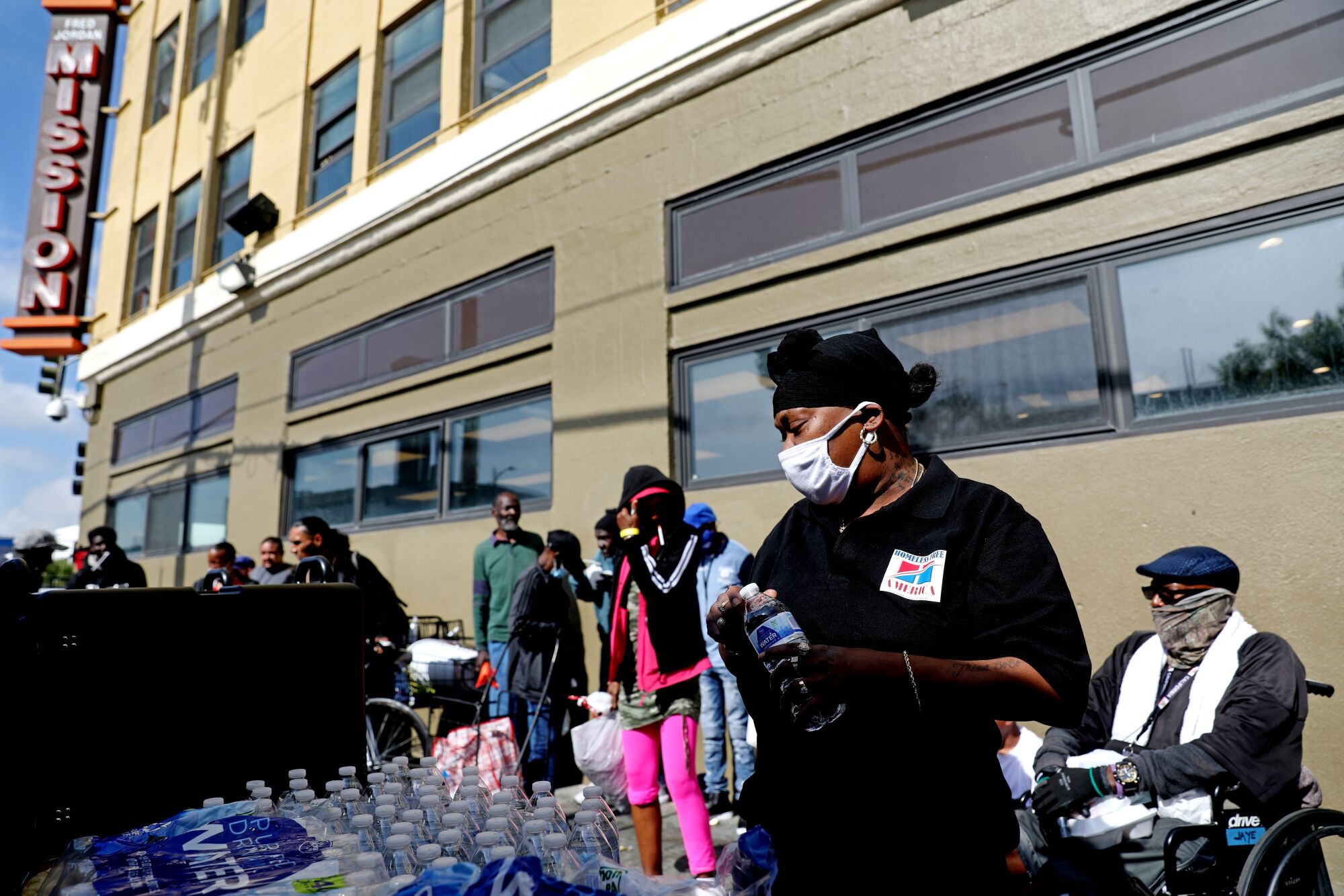 Latasha Bracks hands out water bottles on skid row