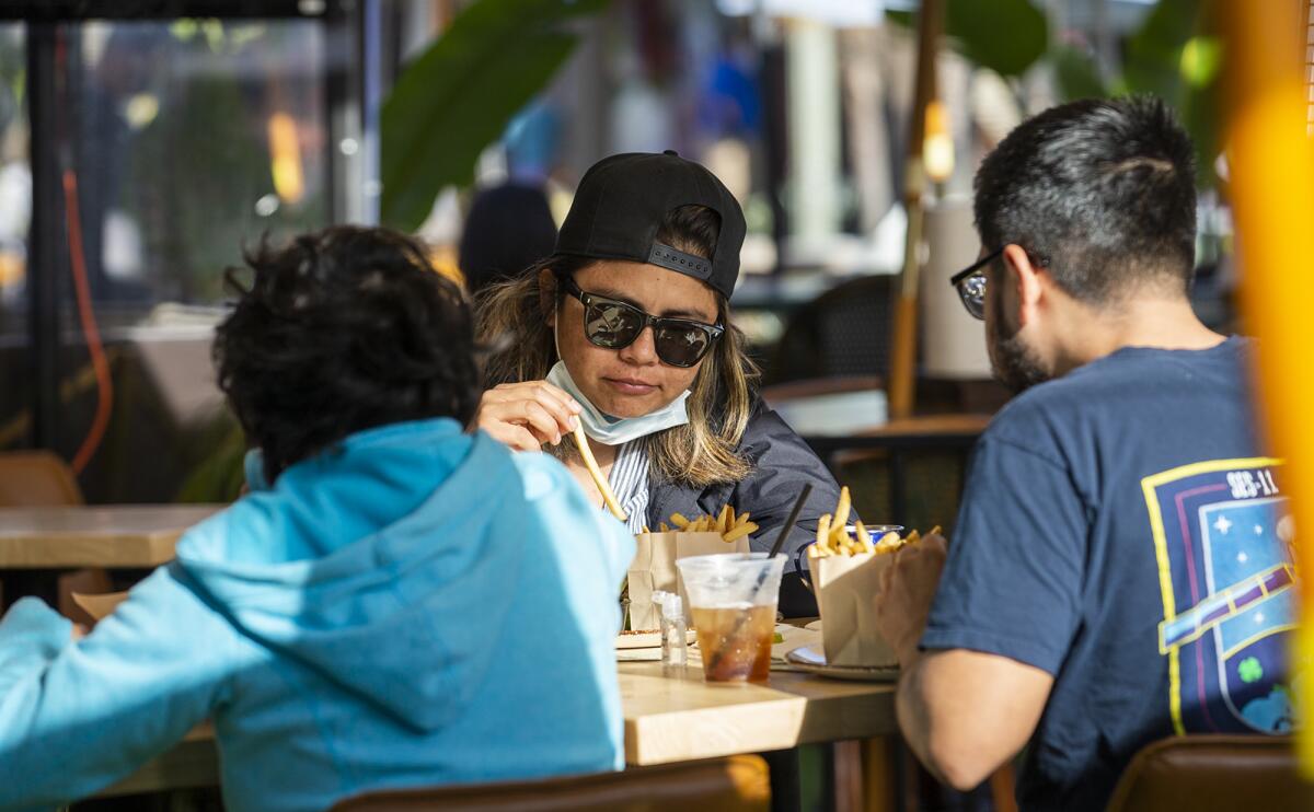 Jasmine Ramirez, left, Fabiola Struchen, center, and Carlos Ramirez have lunch at Killarneys Irish Pub in Huntington Beach.