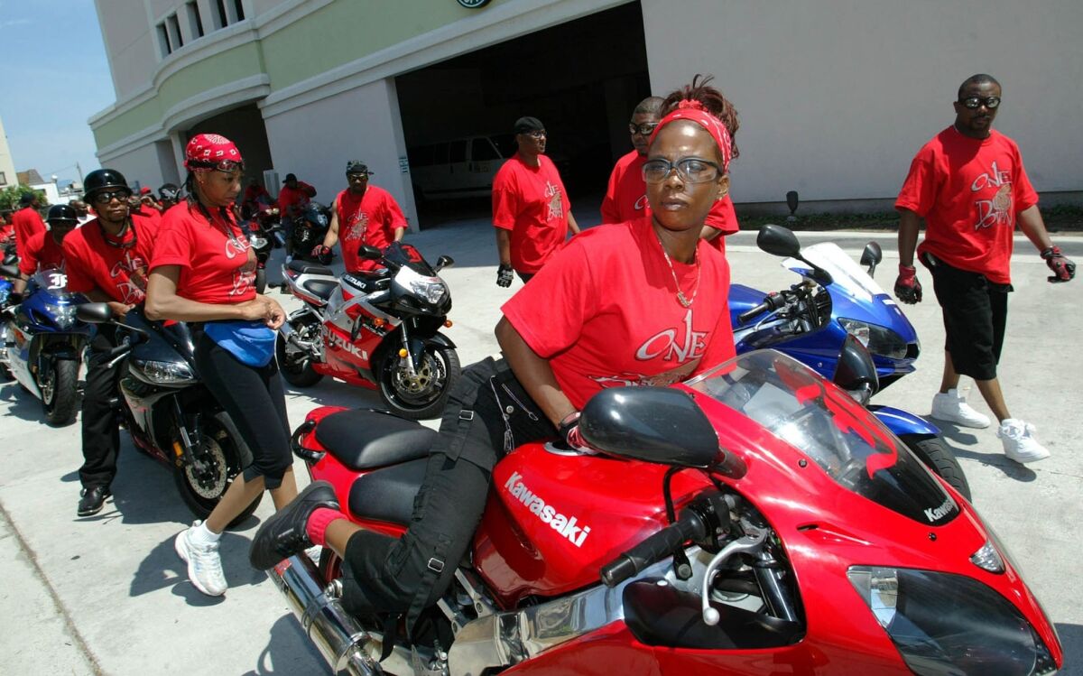FILE - In this May 27, 2005, file photo Janine Bivens, front, mounts her sport motorcycle for a ride with her friends in Myrtle Beach, S.C. The beach town in South Carolina is in the second week of a federal trial over whether it discriminates against thousands of Black tourists who visit every May to celebrate motorcycle culture. (AP Photo/Willis Glassgow, File)