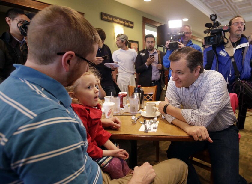 Ted Cruz talks to diners in an Indianapolis restaurant.