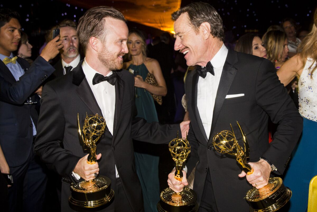 "Breaking Bad" stars Aaron Paul, left, with his Emmy for best supporting actor in a drama series, and Bryan Cranston, with Emmys for best actor and producer in a drama series, at the post-ceremony Governors' Ball in the L.A. Convention Center.
