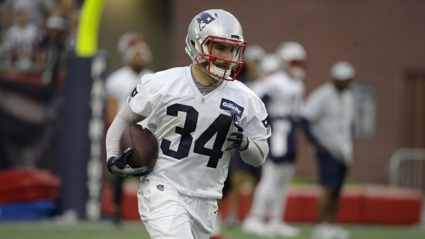 New England Patriots running back Rex Burkhead runs during a training camp practice.