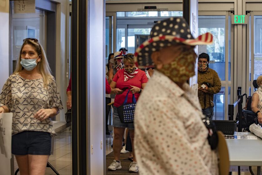 RIVERSIDE, CALIFORNIA - MAY 5, 2020: Protesters who want the public health orders rescinded, enter the County Administrative Center to speak and listen during the Riverside County Board of Supervisors meeting in the midst of the ongoing coronavirus pandemic on May 5, 2020 in Riverside, California. (Gina Ferazzi/Los Angeles Times)