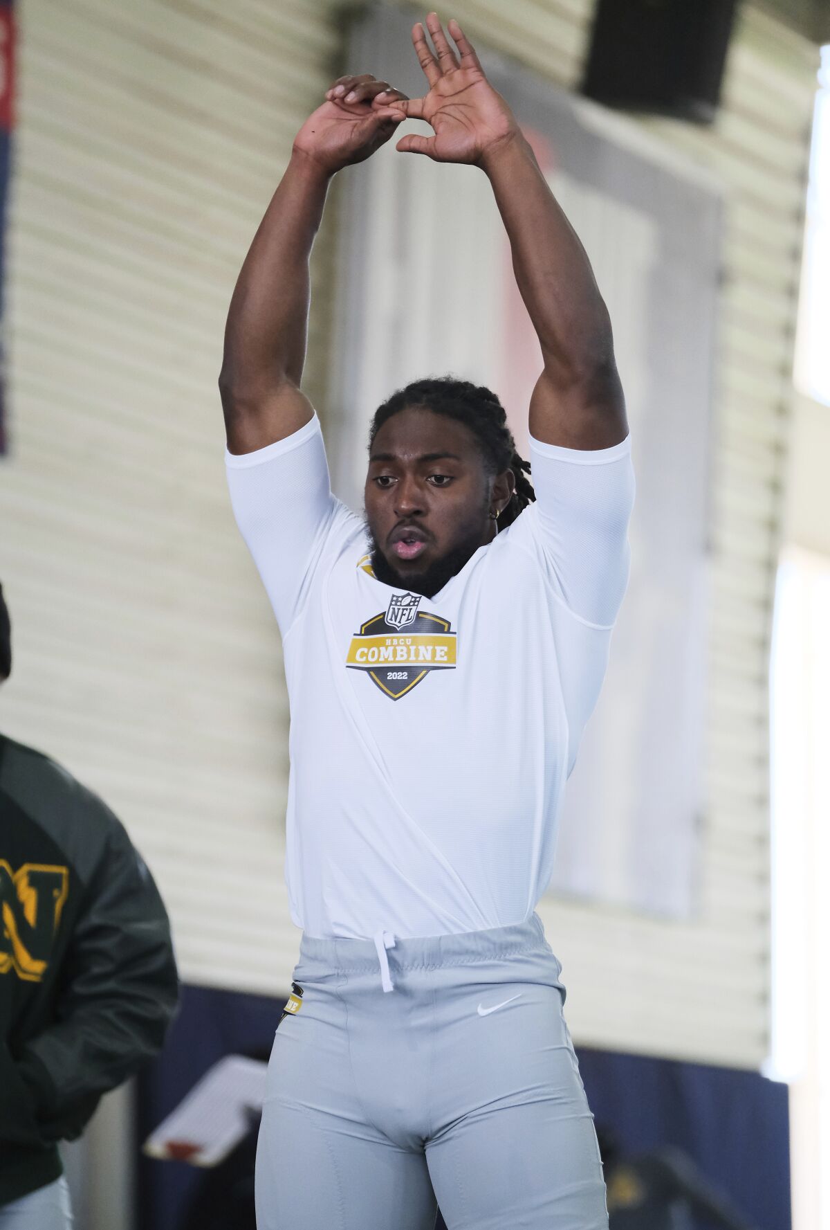 Alabama State running back Ezra Gray stretches out before doing a broad jump at the NFL HBCU Combine at the University of South Alabama in Mobile, Ala. on Saturday, Jan. 29, 2022. Nearly a year after no HBCU players were selected in the NFL Draft, Gray and other products of of historically black colleges and universities have somethig to prove. (Dan Anderson/AP Images for NFL)