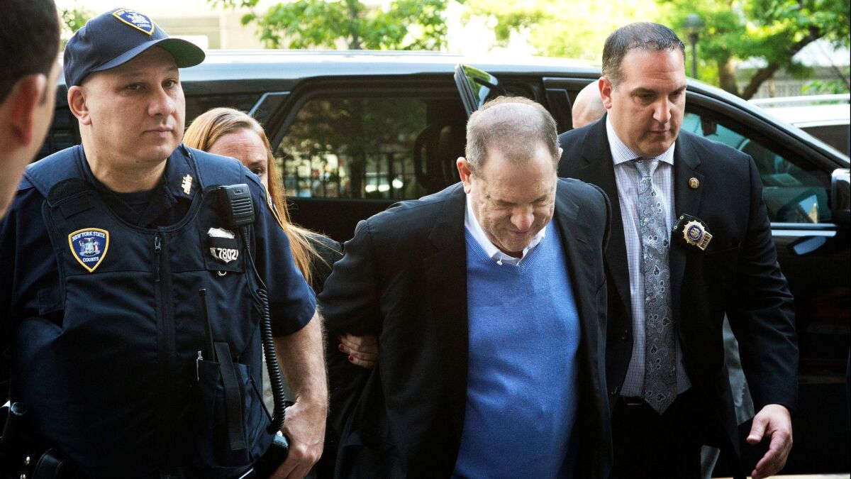 Harvey Weinstein is escorted into court, Friday, May 25, 2018, in New York. Weinstein surrendered Friday to face rape and other charges from encounters with two women. (AP Photo/Mark Lennihan)