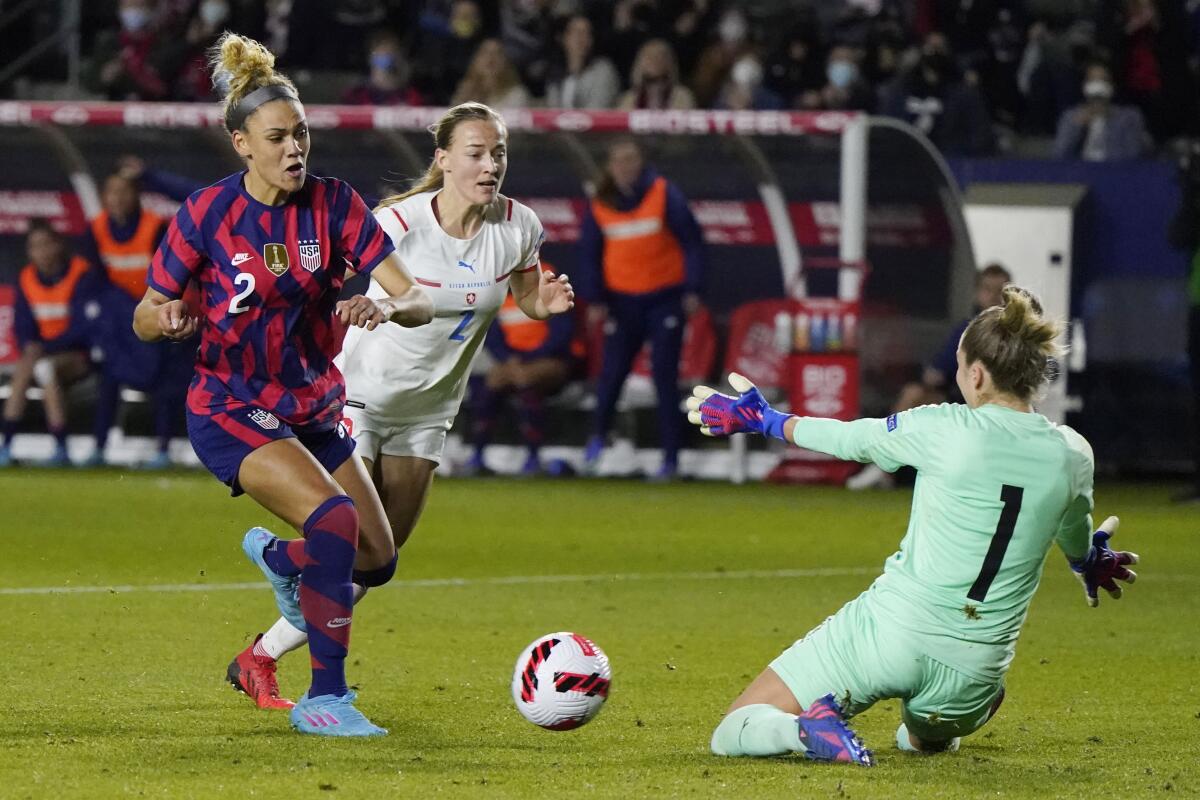 Czech Republic goalkeeper Barbara Votikova stops a shot from United States' Trinity Rodman.