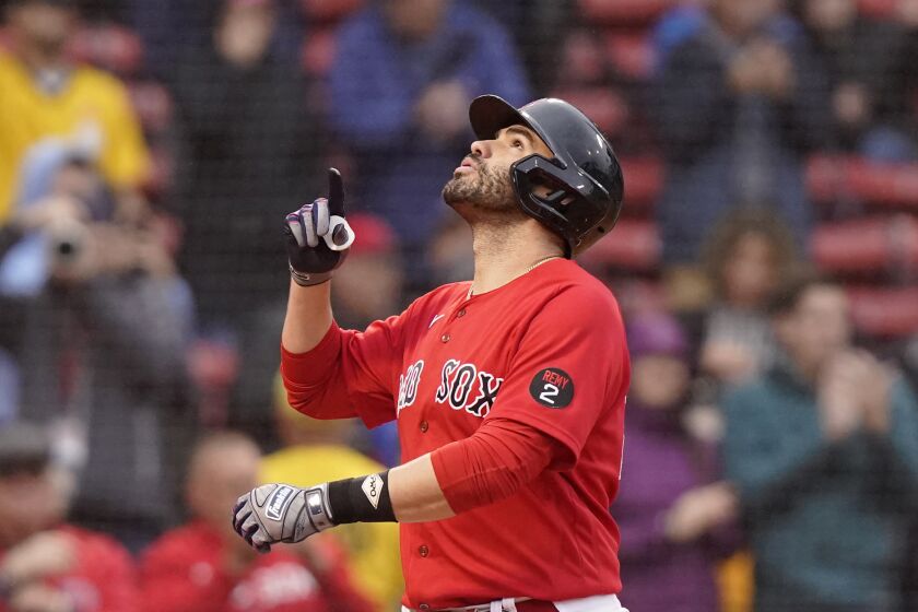 Boston Red Sox's J.D. Martinez celebrates his three-run home run as he arrives home in the first inning of a baseball game against the Tampa Bay Rays, Wednesday, Oct. 5, 2022, in Boston. (AP Photo/Steven Senne)