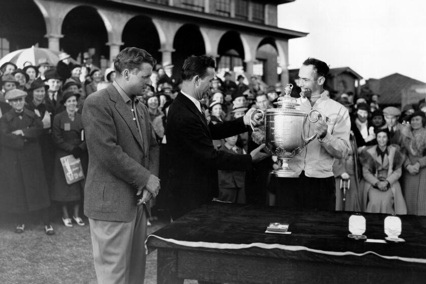 FILE - Denny Shute, right, is presented with the PGA Championship trophy at Pinehurst Country Club in Pinehurst, N.C., Nov. 22, 1936. Shute defeated Jimmy Thomson, left, in the final round, 3 and 2. Presenting the trophy is George Jacobus, president of the Professional Golfers' Association. Shute was the first major champion at Pinehurst. (AP Photo, File)