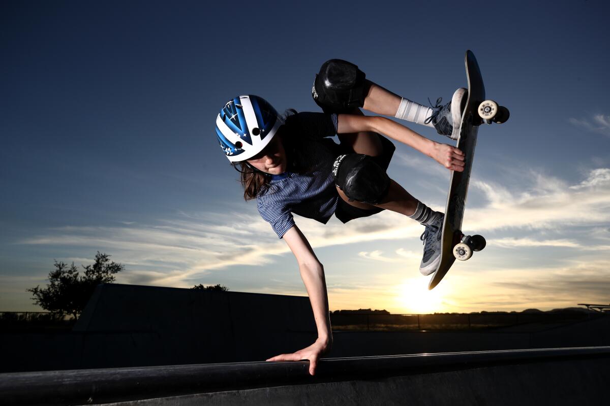 Skateboarder Minna Stess trains at a skatepark in Napa, Calif., as the sun sets behind her.