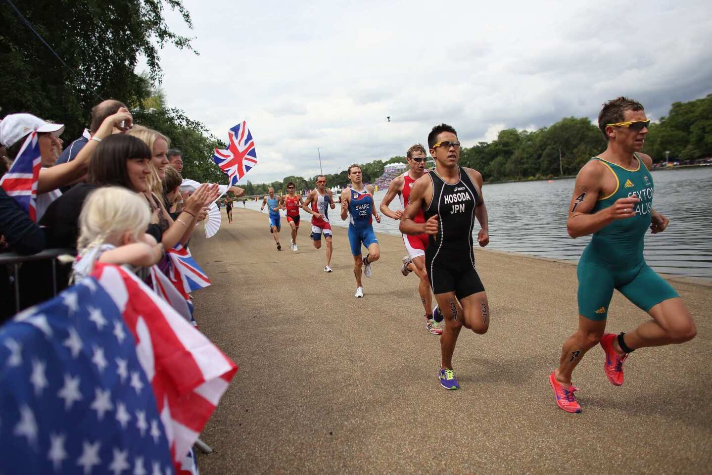 Athletes compete in the running stage of the men's triathlon through Hyde Park.