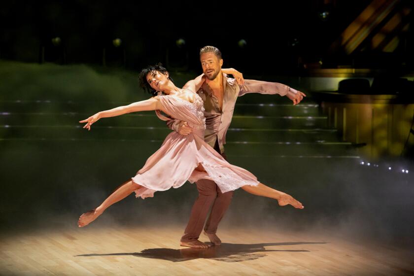 Derek Hough holds wife Hayley Hough in the air during a dance routine on the Oct. 15 episode of 'Dancing with the Stars'