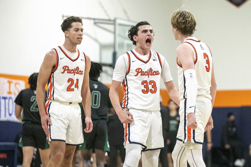 Costa Mesa, CA - January 27: Pacifica Christian Orange County's Alex Stewart, left, Salim Semaan, center, and Parker Strauss celebrates after hitting a three point shot at the end of the third period during a San Joaquin League game against Fairmont Prep on Friday, Jan. 27, 2023 in Costa Mesa, CA. (Scott Smeltzer / Daily Pilot)