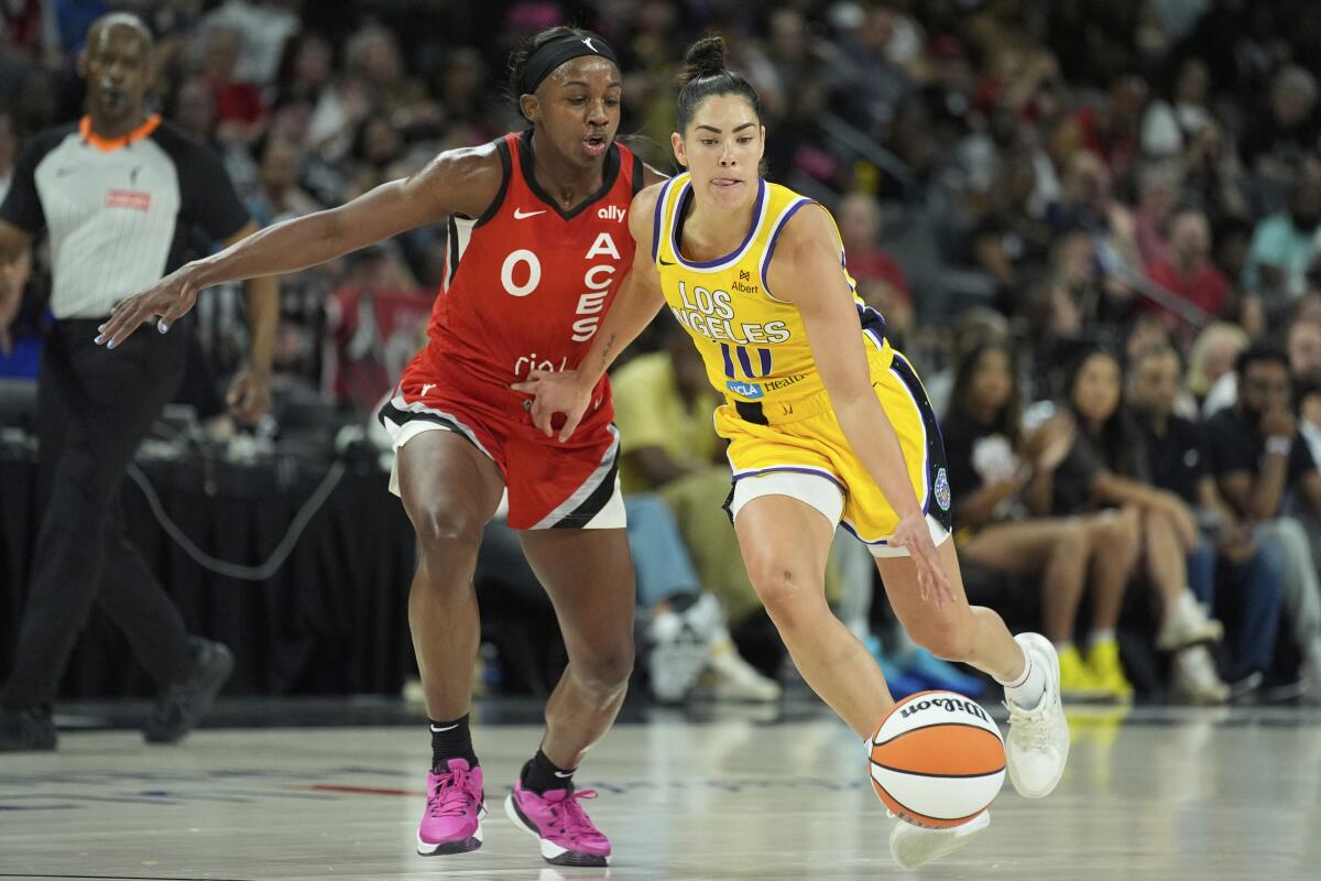 Sparks guard Kelsey Plum, right, drives against Las Vegas guard Jackie Young.