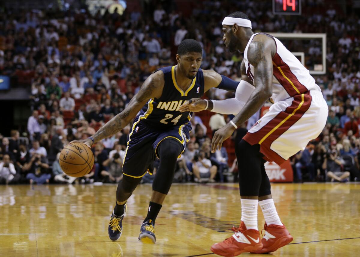 Indiana's Paul George drives to the basket against Miami's LeBron James on April 11.