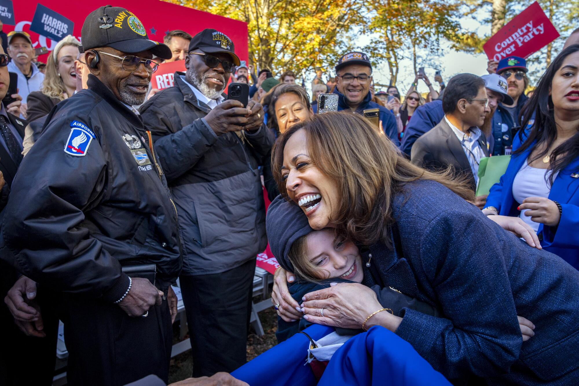 Democratic presidential candidate Vice President Kamala Harris hugs a child after speaking duri