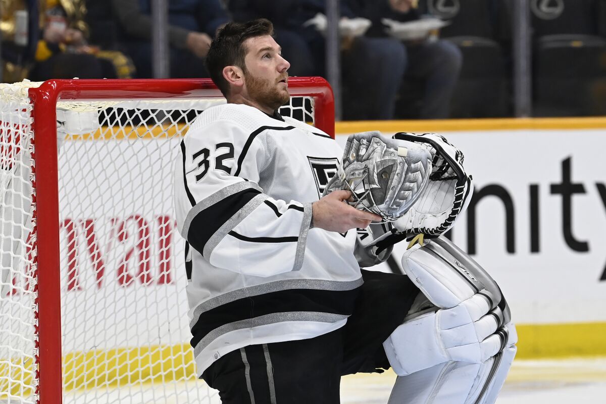 Kings goaltender Jonathan Quick holds his mask during a timeout against the Nashville Predators on Jan. 21.