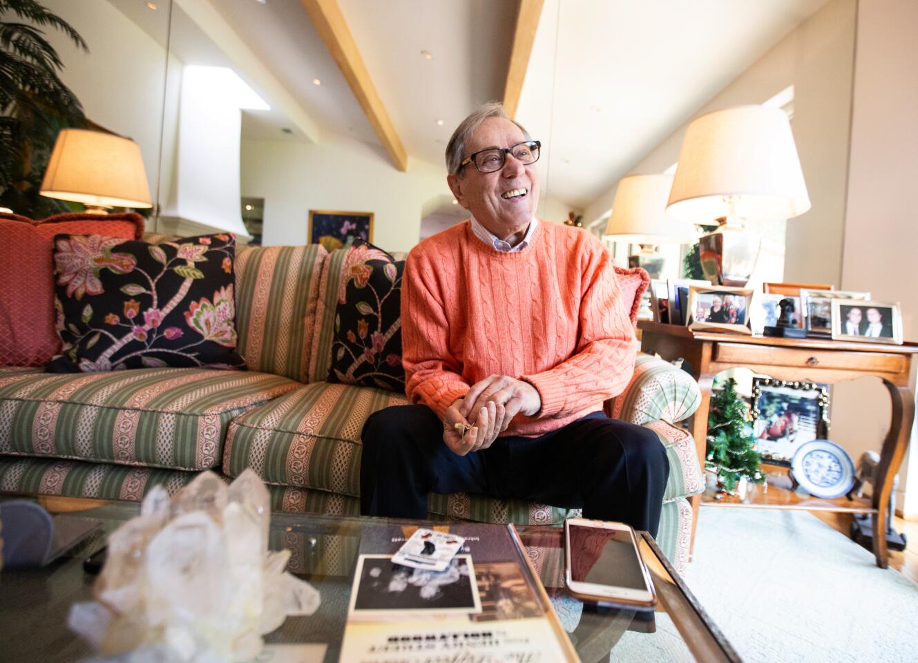 Los Angeles CA., December 18, 2019: Howard Storm, legendary TV director from the 70s, 80s, 90s, laughs as he changes his hearing aid in his living room at his home in Beverly Hills on Wednesday, December 18, 2019 in Los Angeles, California. Strom directed shows like "Happy Days," "Mork and Mindy" and many others. He also cast Jim Carrey in his first movie.(Jason Armond / Los Angeles Times)
