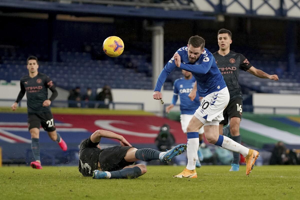 Everton's Gylfi Sigurdsson has a shot on goal blocked by Manchester City's Ruben Dias.