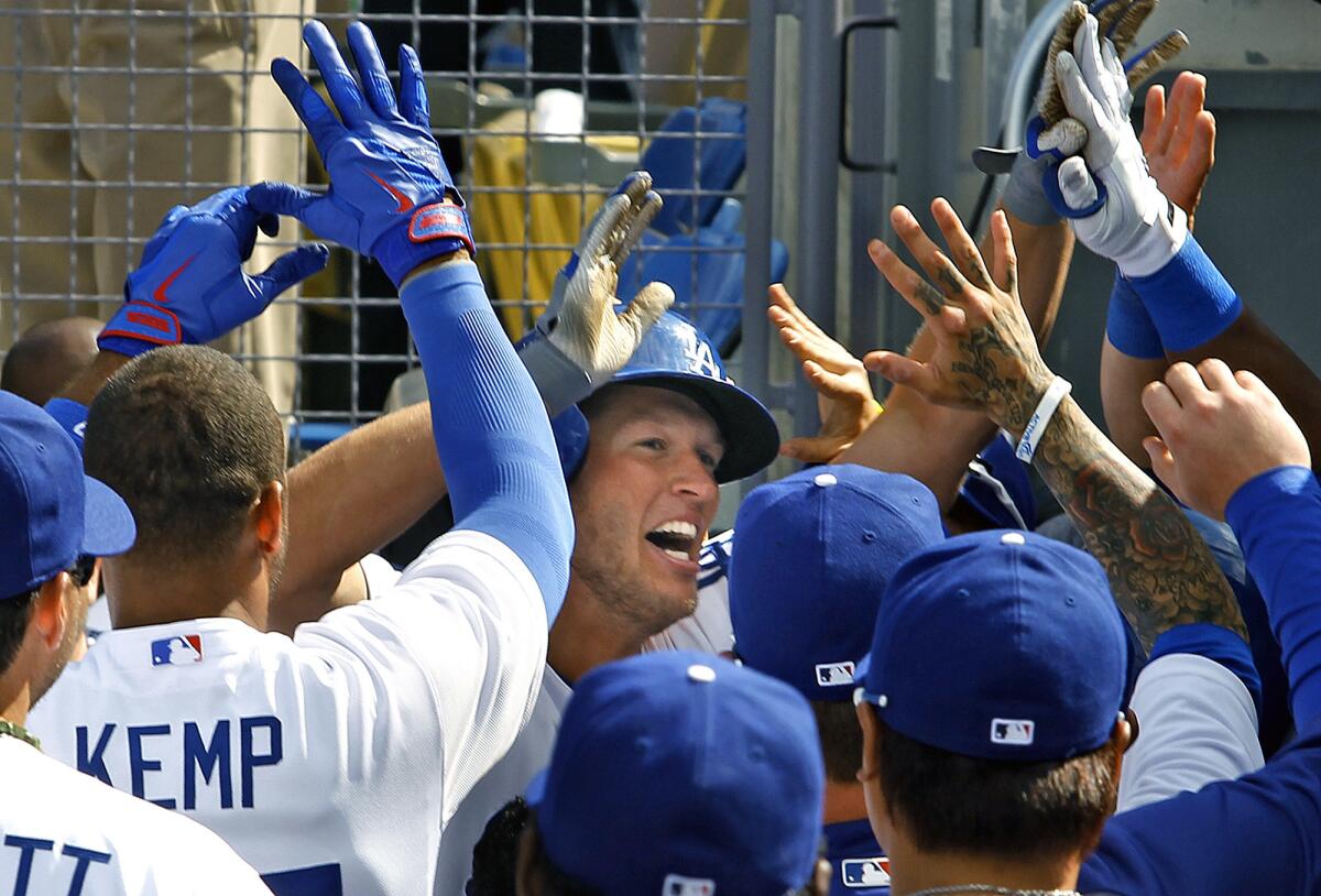 Clayton Kershaw celebrates after hitting a home run against the San Francisco Giants on opening day 2013 at Dodger Stadium.