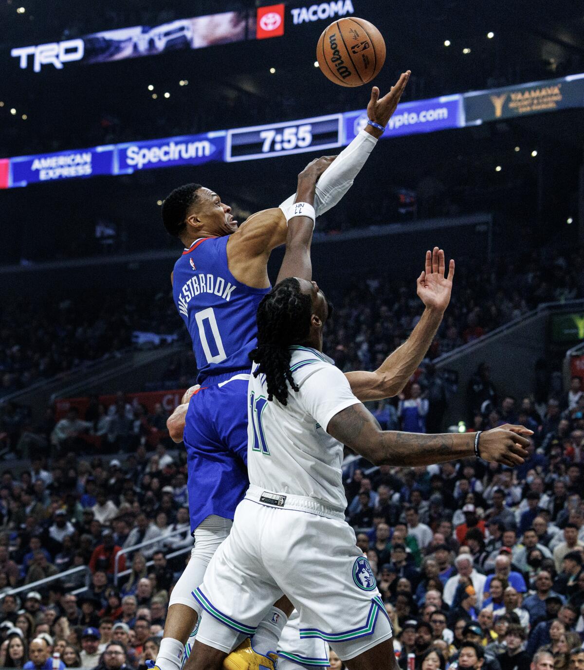 Clippers guard Russell Westbrook, top, is fouled by Minnesota Timberwolves center Naz Reid.