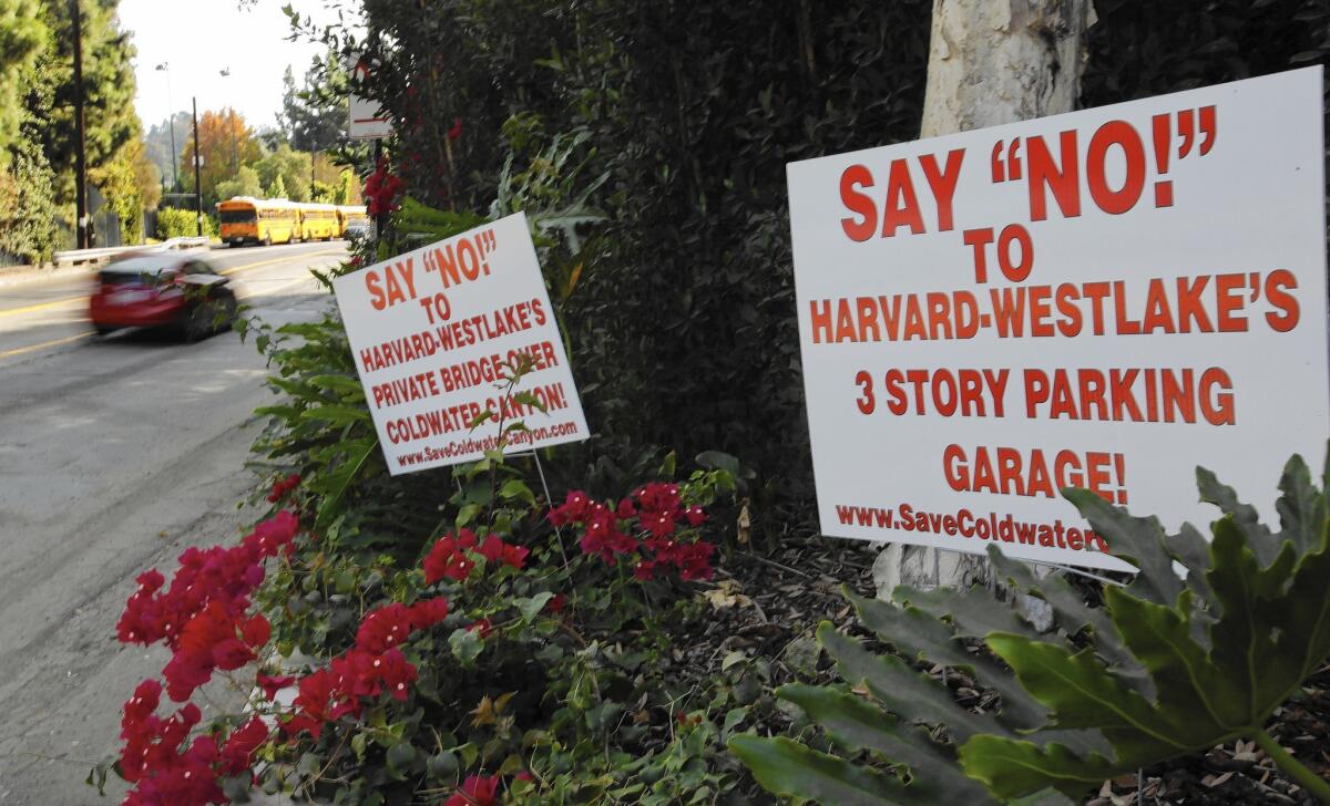 Signs opposing Harvard-Westlake School's proposed 750-space parking structure are posted along Coldwater Canyon Avenue in Studio City.