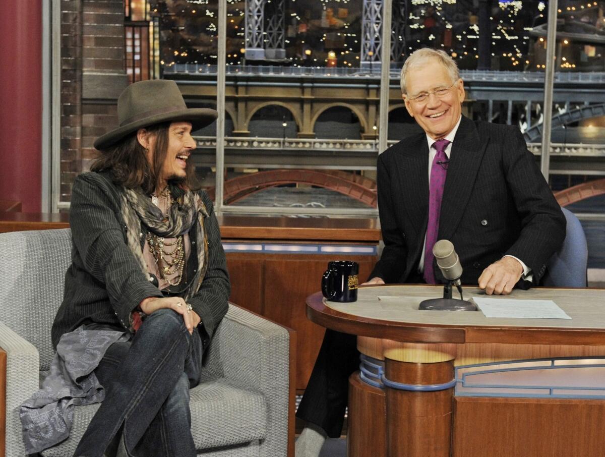 "Lone Ranger" star Johnny Depp, left, joins host David Letterman the set of the "Late Show with David Letterman."