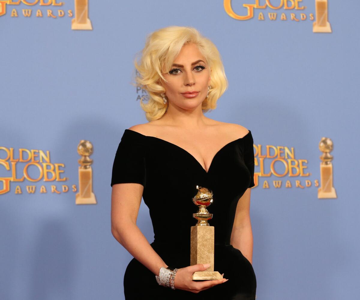 Lady Gaga poses with her Golden Globe at the Beverly Hilton Hotel on Jan. 10.