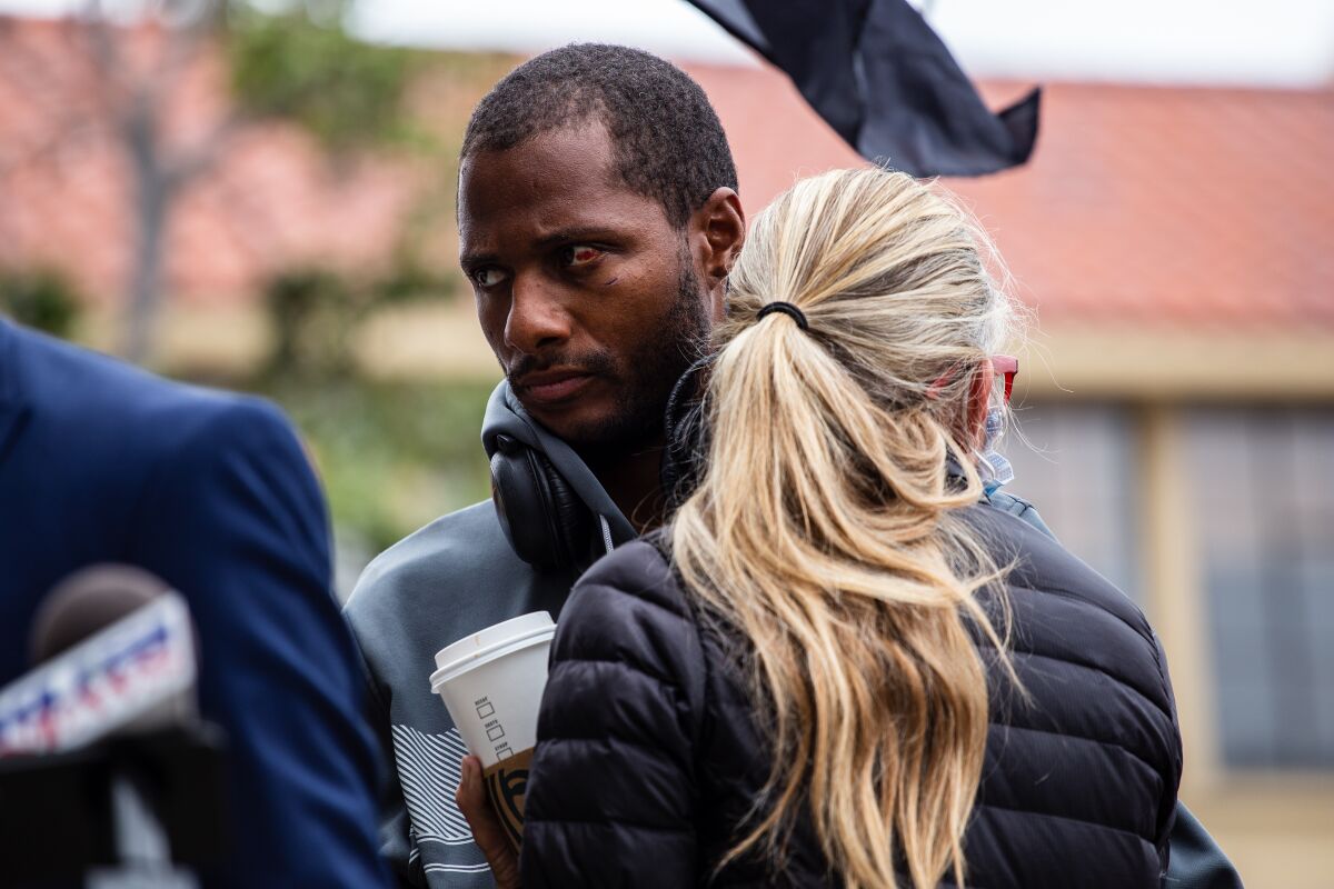 Jesse Evans embraces community member and friend Amie Zamudio during a news conference in May about his arrest in La Jolla.