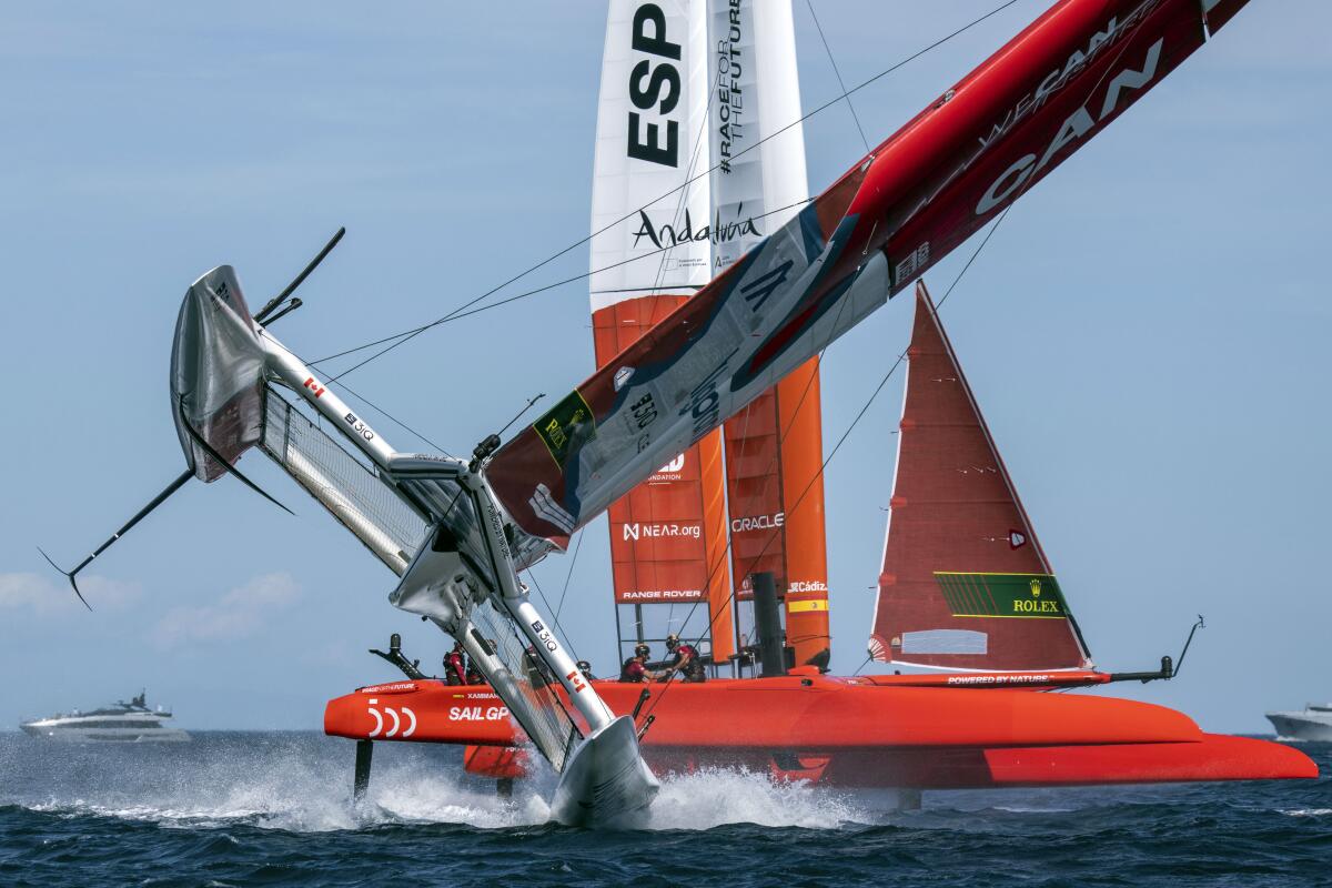 Canada SailGP Team helmed by Phil Robertson nearly capsize as Spain SailGP Team helmed by Jordi Xammar sail closely past during the second race on Race Day 1 of the Range Rover France Sail Grand Prix in Saint Tropez, France, Saturday, Sept. 10, 2022. (Bob Martin/SailGP via AP)