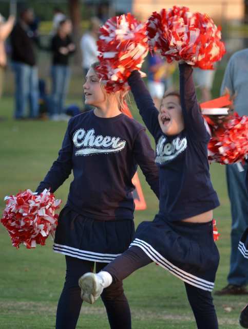 The cheerleading squad travels from field to field cheering for each game.