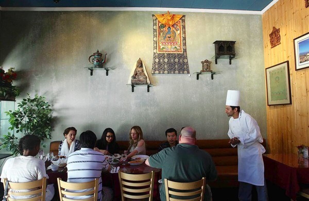 Chef Chudamani Adhikari checks on customers at Himalayan Cafe in Old Pasadena.