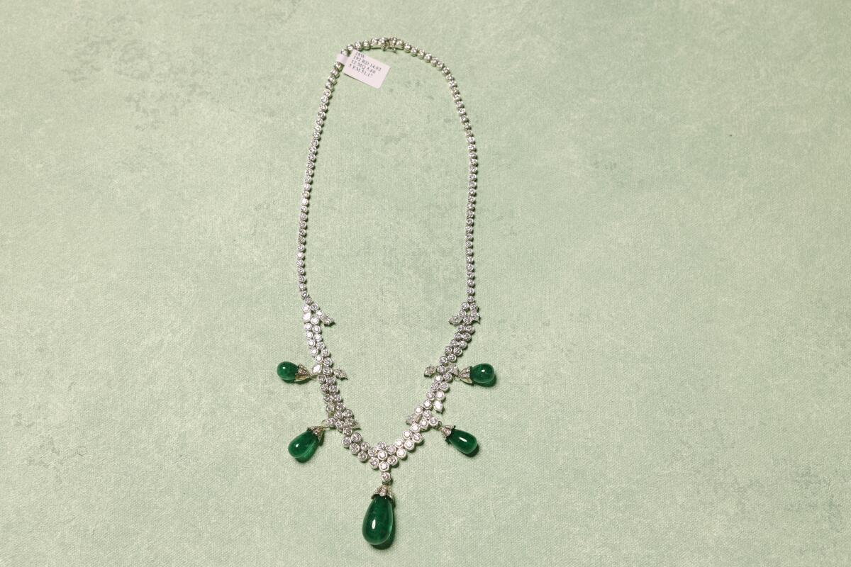 A white gold necklace with diamonds and emeralds at the office of Forty-Seventh & Fifth.