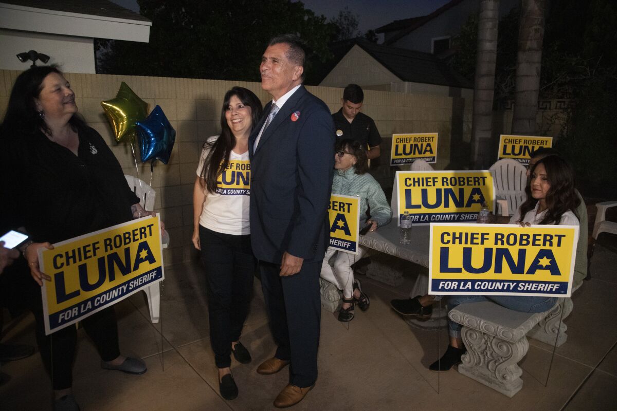 Retired Long Beach Police Chief Robert Luna, center, and his wife, Celines, celebrate primary election night.