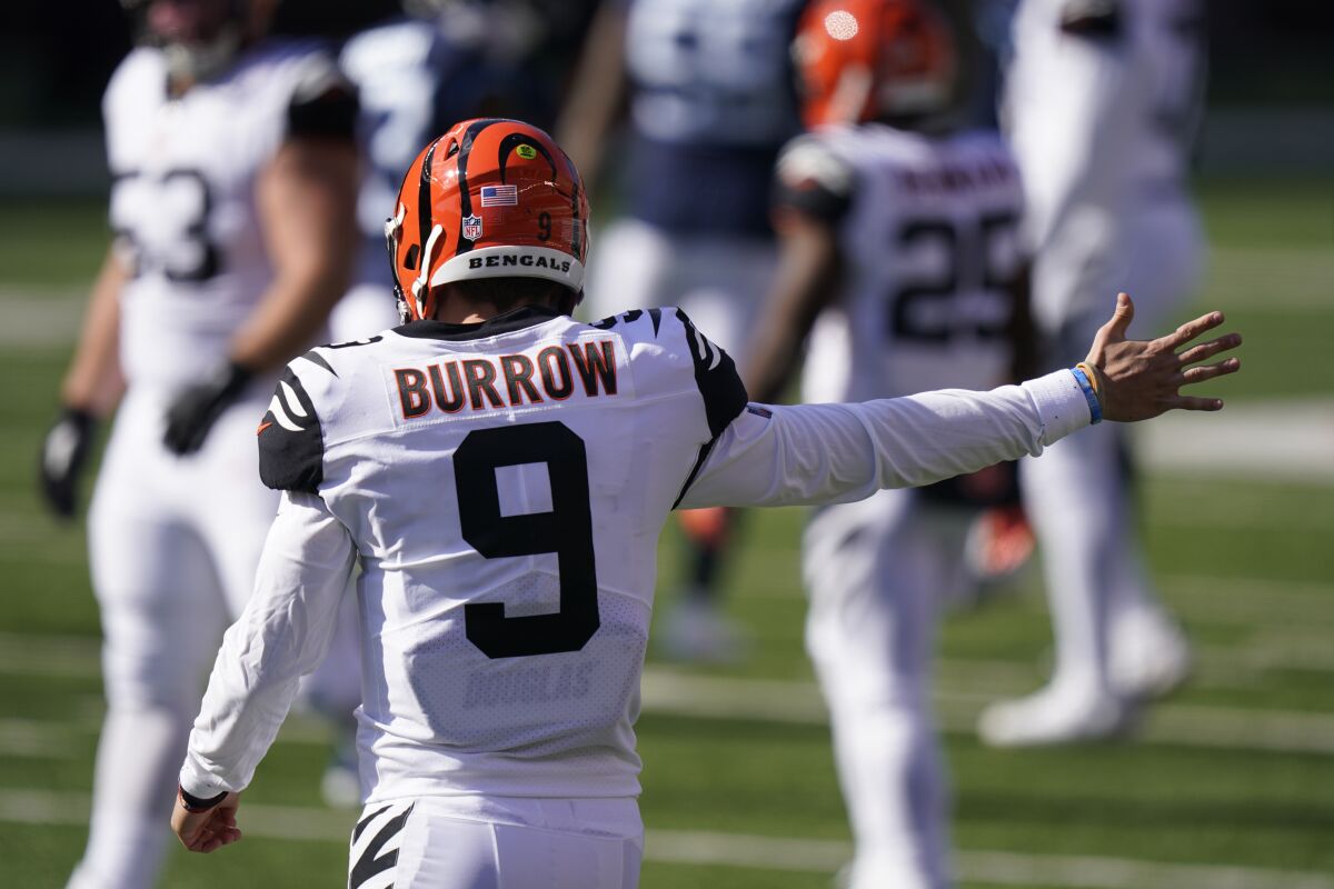 Cincinnati Bengals quarterback Joe Burrow (9) motions a first down during the first half of an NFL football game against the Tennessee Titans, Sunday, Nov. 1, 2020, in Cincinnati. (AP Photo/Bryan Woolston)