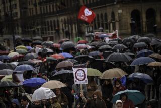 FILE - A teenager from the 'Right to Live Platform', bottom, holds a banner which reads: ''Abortion Zero'', as she takes part during a demonstration against pregnancy termination, in Pamplona northern Spain, March 23, 2014. Spain is awaiting the publication in coming days of a new law banning the intimidation or harassment of women entering abortion clinics. The law comes into force when it is published in the Government Gazette, possibly next week, after the Spanish Senate on Wednesday, April 6, 2022 endorsed a law passed earlier by parliament. (AP Photo/Alvaro Barrientos, file)