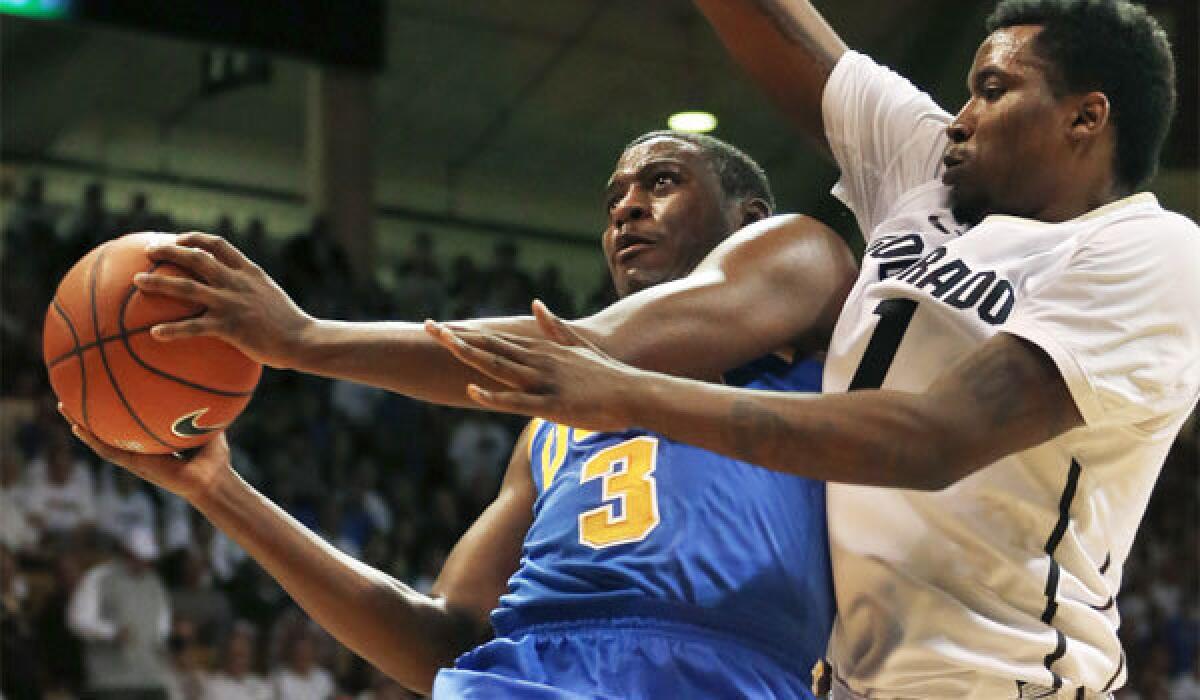 UCLA's Jordan Adams, left, eyes the basket against Colorado's Wesley Gordon on Jan. 16.