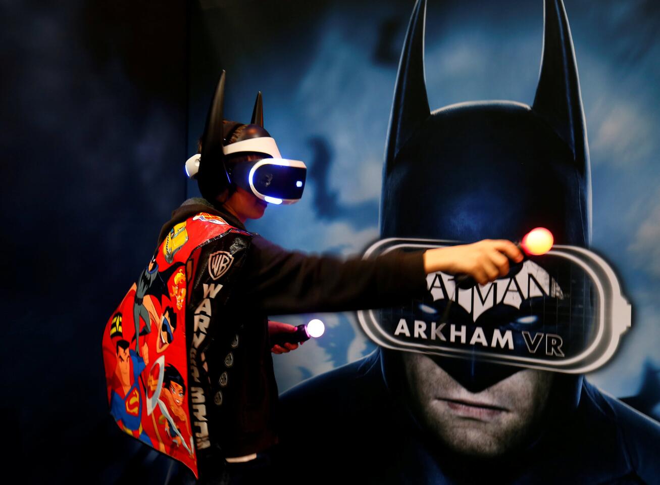 An attendee plays aVR game of Batman at a booth on the convention floor during the opening day of Comic-Con International in San Diego, California