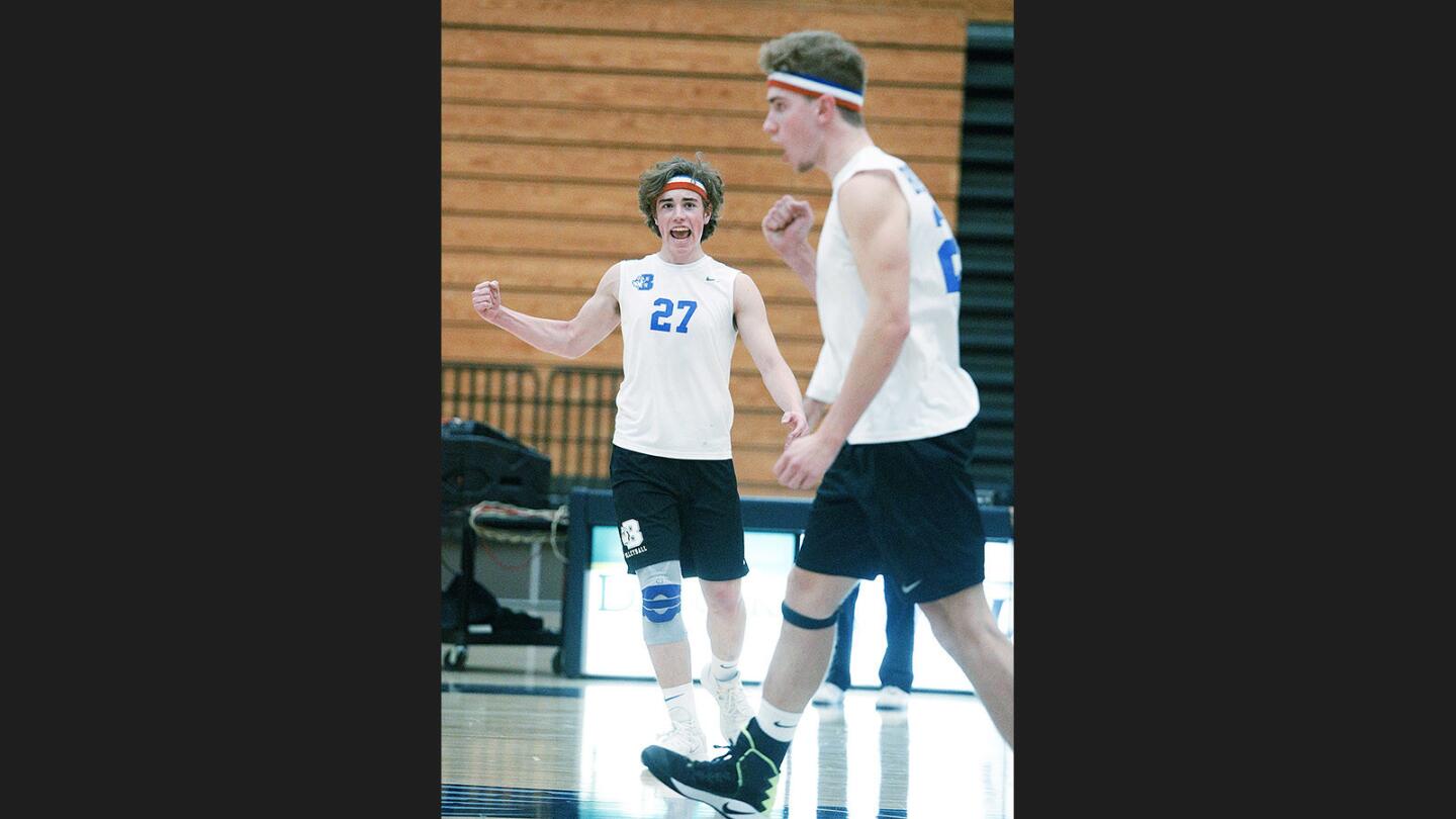 Burbank's Ryan Rickey and Rory Rickey celebrate a point won against Burbank in a Pacific League boys' volleyball match at Crescenta Valley High School on Thursday, March 15, 2018. Burbank won the match 3-2.