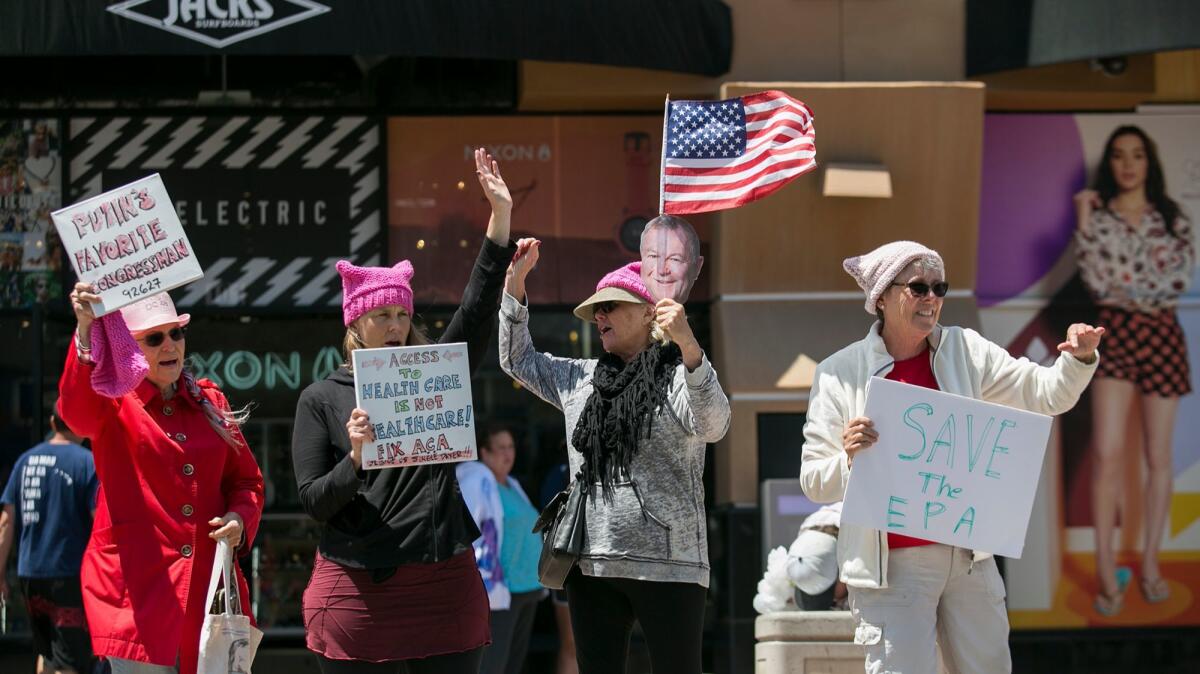 Members of Indivisible OC protest outside Rep. Dana Rohrabacher's office in Huntington Beach on Tuesday.