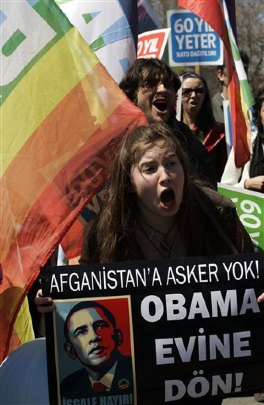 A group of Turkish leftist shout slogans while protesting against NATO in Istanbul, Turkey, Saturday, April 4, 2009. The banner with a photo of U. S. President Barack Obama reads: "No soldier for Afghanistan! Obama go back home!" (AP Photo/Ibrahim Usta)