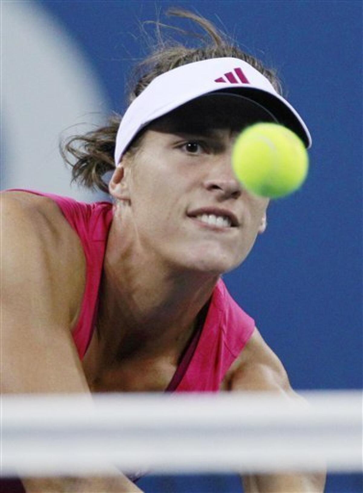 Andrea Petkovic, of Germany, keeps her eyes on the ball as she drops a shot over the net against Vera Zvonareva, of Russia, at the U.S. Open tennis tournament in New York, Monday, Sept. 6, 2010.(AP Photo/Charles Krupa)