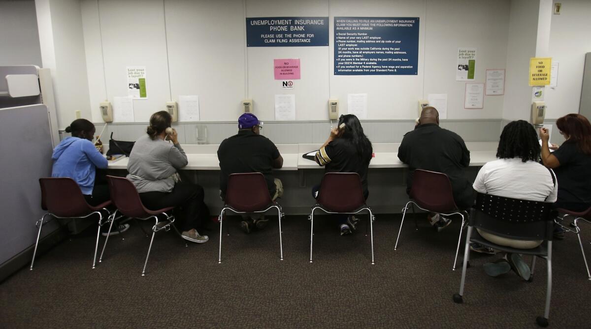 Visitors use the phone bank in the Employment Development Department's Sacramento office. A community group is mounting a campaign to reform California's unemployment insurance program. The lifeline for the state's jobless has experienced payment delays due to a botched IT upgrade late last summer.